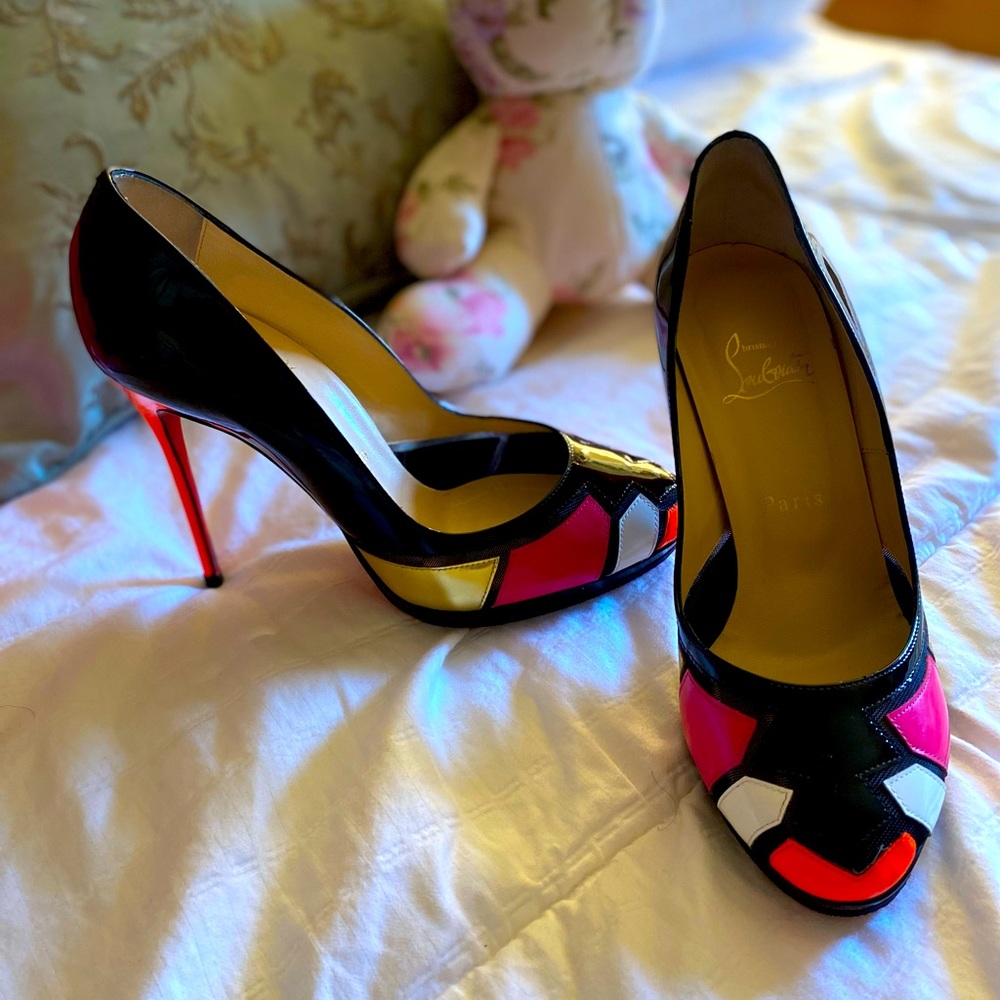 Classic black pumps, with fluorescent orange and pink accents at the toe.